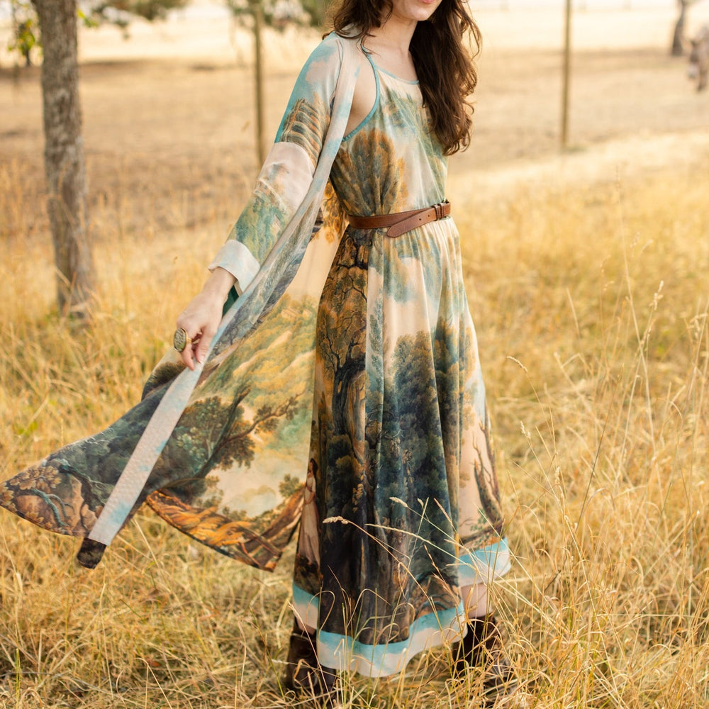 
                  
                    Soft bamboo viscose Bohéme slip dress featuring 18th-century Tivoli waterfalls and Lady Liberty artwork, designed to celebrate self-love and personal power – Market of Stars.
                  
                