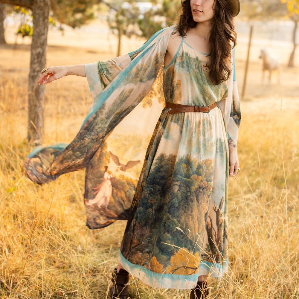 
                  
                    Soft bamboo viscose Bohéme slip dress featuring 18th-century Tivoli waterfalls and Lady Liberty artwork, designed to celebrate self-love and personal power – Market of Stars.
                  
                