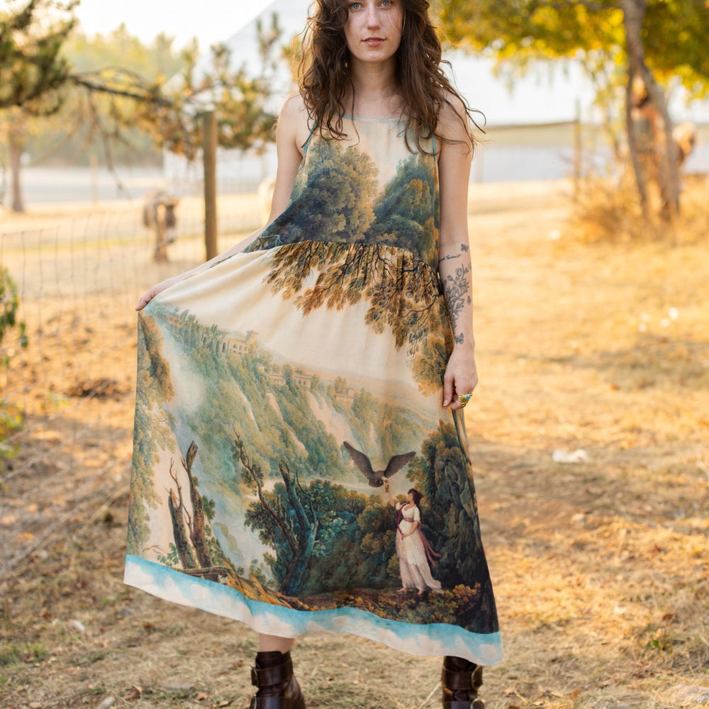 
                  
                    Soft bamboo viscose Bohéme slip dress featuring 18th-century Tivoli waterfalls and Lady Liberty artwork, designed to celebrate self-love and personal power – Market of Stars.
                  
                