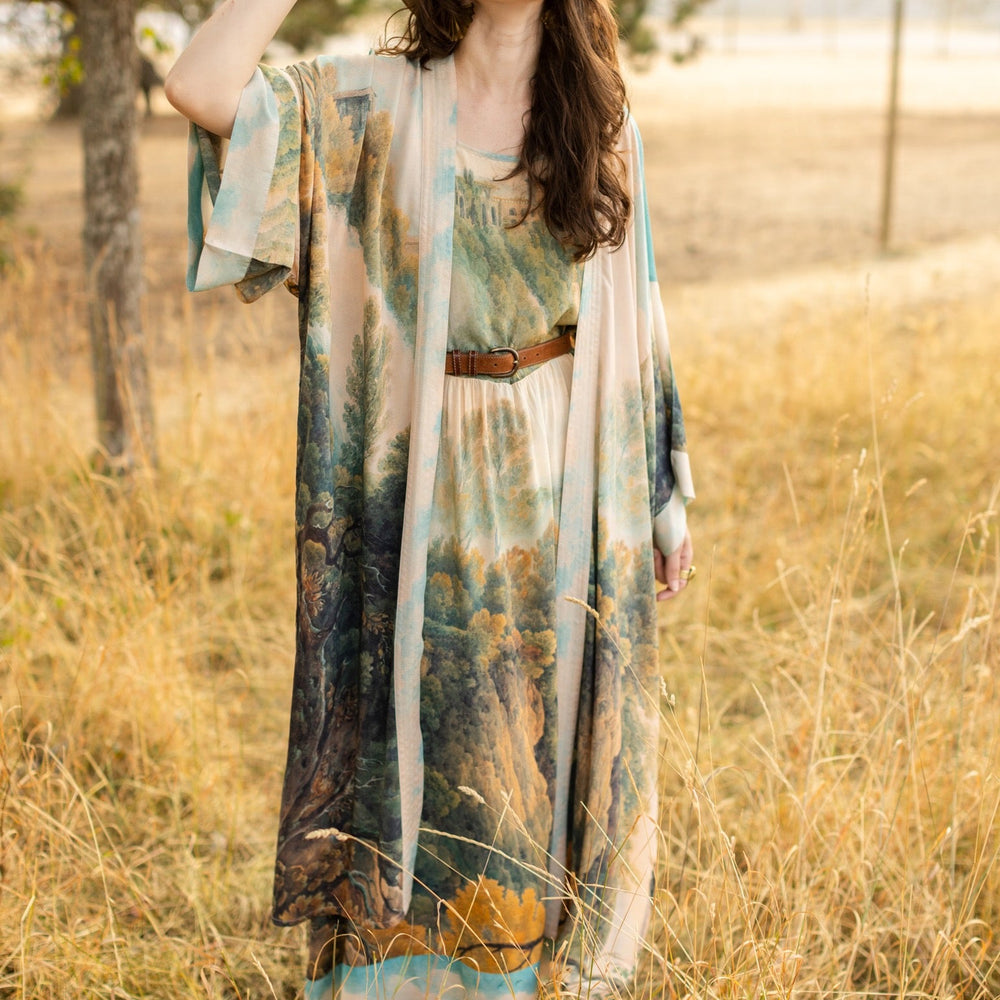 
                  
                    Soft bamboo viscose Bohéme slip dress featuring 18th-century Tivoli waterfalls and Lady Liberty artwork, designed to celebrate self-love and personal power – Market of Stars.
                  
                