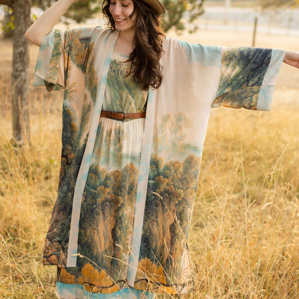 
                  
                    Soft bamboo viscose Bohéme slip dress featuring 18th-century Tivoli waterfalls and Lady Liberty artwork, designed to celebrate self-love and personal power – Market of Stars.
                  
                