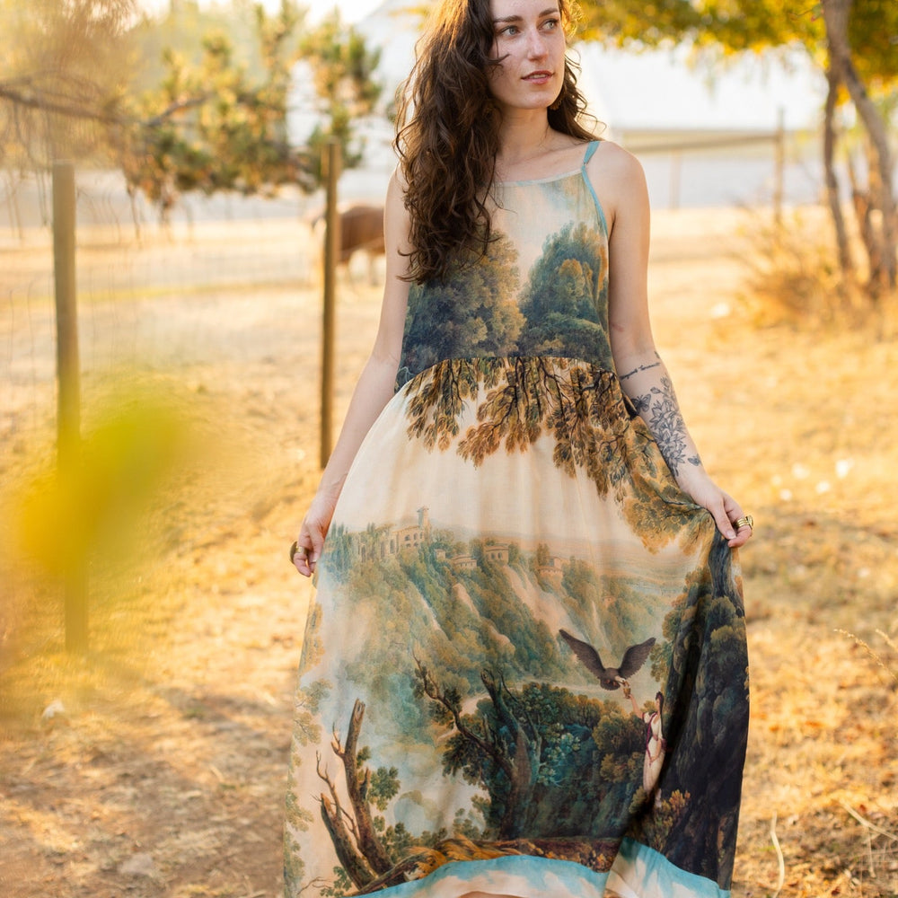 
                  
                    Soft bamboo viscose Bohéme slip dress featuring 18th-century Tivoli waterfalls and Lady Liberty artwork, designed to celebrate self-love and personal power – Market of Stars.
                  
                