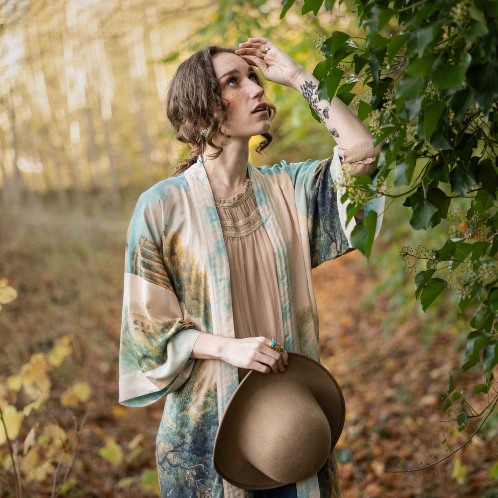 
                  
                    Romantic kimono featuring 18th-century Tivoli waterfalls and Lady Liberty art in a soft, painterly palette celebrating strength and self-love – Market of Stars.
                  
                