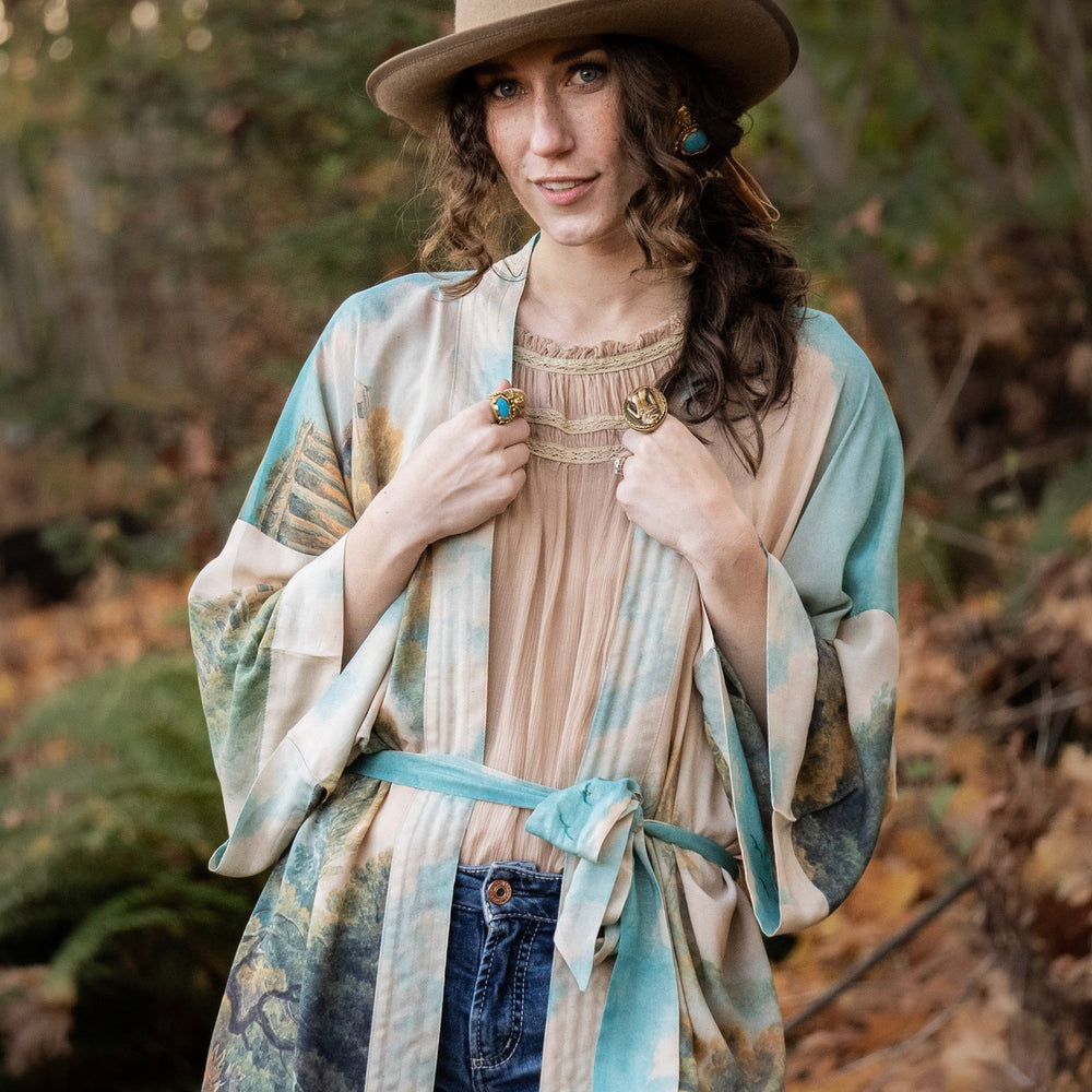 
                  
                    Romantic kimono featuring 18th-century Tivoli waterfalls and Lady Liberty art in a soft, painterly palette celebrating strength and self-love – Market of Stars.
                  
                