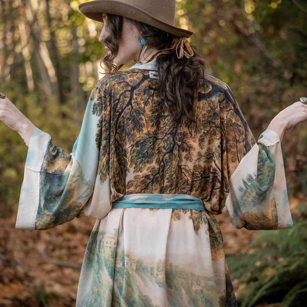 
                  
                    Romantic kimono featuring 18th-century Tivoli waterfalls and Lady Liberty art in a soft, painterly palette celebrating strength and self-love – Market of Stars.
                  
                