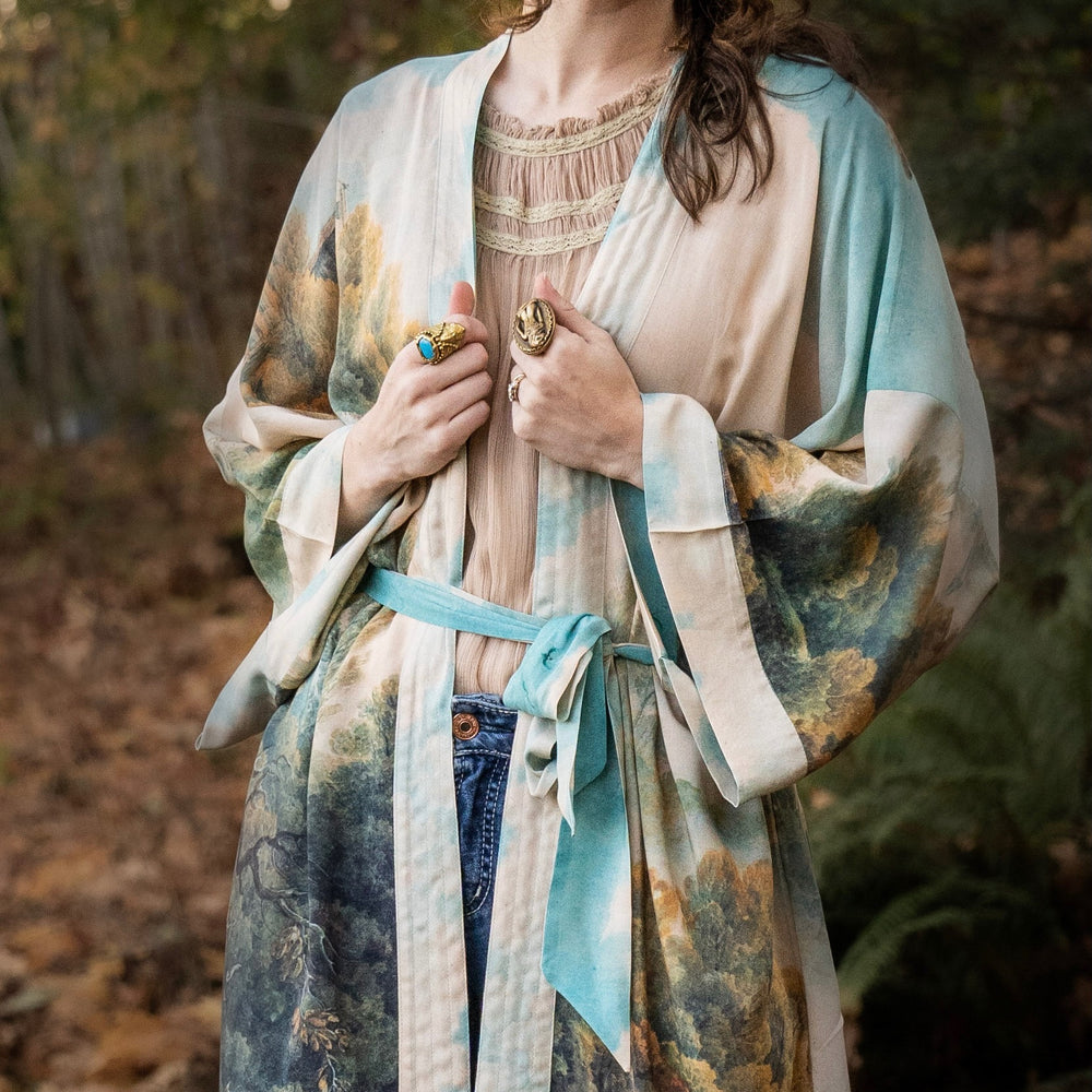 
                  
                    Romantic kimono featuring 18th-century Tivoli waterfalls and Lady Liberty art in a soft, painterly palette celebrating strength and self-love – Market of Stars.
                  
                