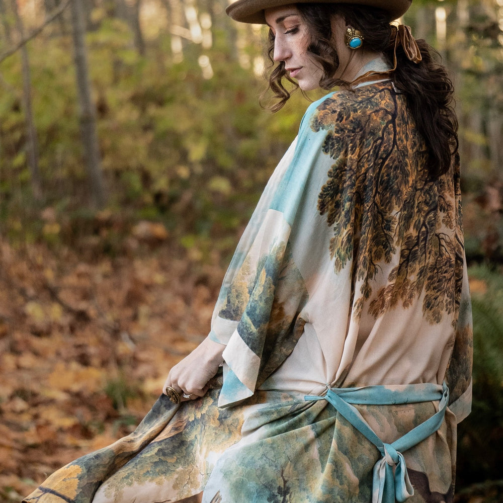 
                  
                    Romantic kimono featuring 18th-century Tivoli waterfalls and Lady Liberty art in a soft, painterly palette celebrating strength and self-love – Market of Stars.
                  
                