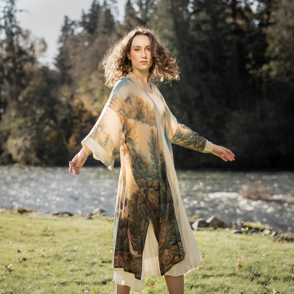 
                  
                    Romantic kimono featuring 18th-century Tivoli waterfalls and Lady Liberty art in a soft, painterly palette celebrating strength and self-love – Market of Stars.
                  
                