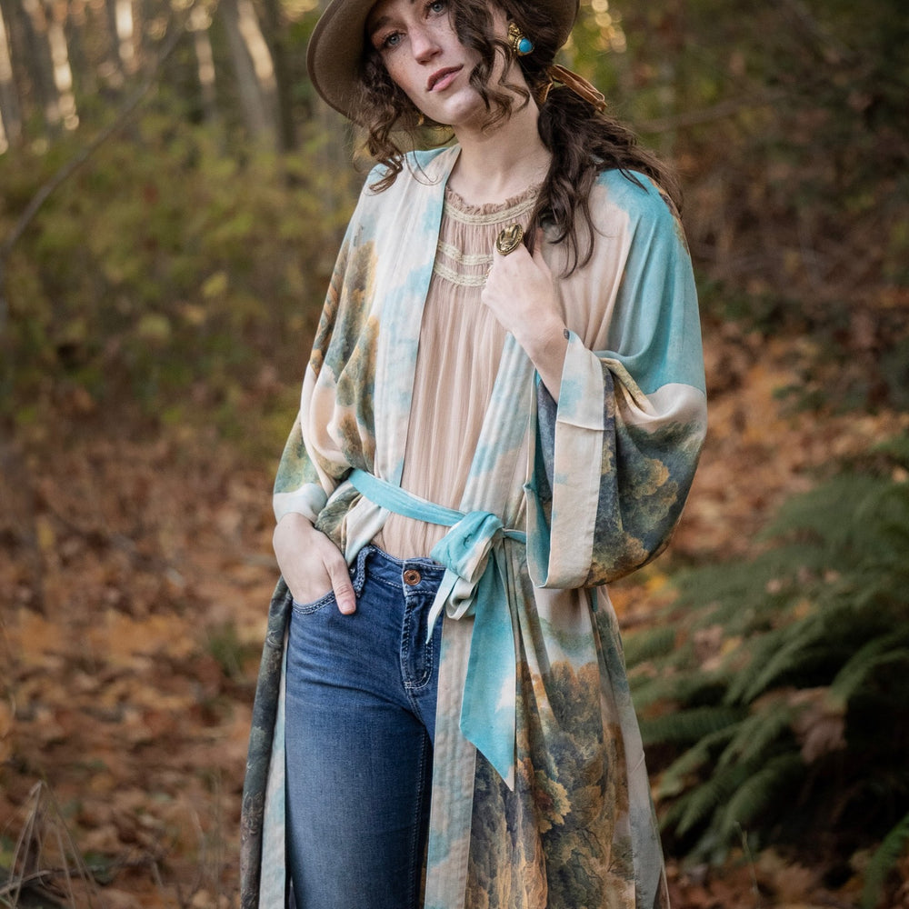 
                  
                    Romantic kimono featuring 18th-century Tivoli waterfalls and Lady Liberty art in a soft, painterly palette celebrating strength and self-love – Market of Stars.
                  
                