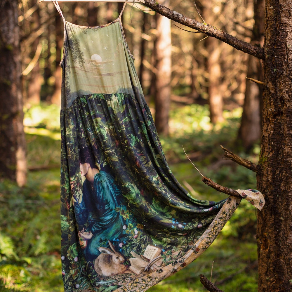 
                  
                    A romantic bamboo-based viscose slip dress featuring a moonlit river scene, a seated woman painted by Dante Gabriel Rossetti, and a hidden quote from a 1700s ring – Market of
                  
                