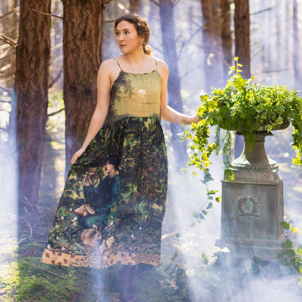 
                  
                    A romantic bamboo-based viscose slip dress featuring a moonlit river scene, a seated woman painted by Dante Gabriel Rossetti, and a hidden quote from a 1700s ring – Market of
                  
                