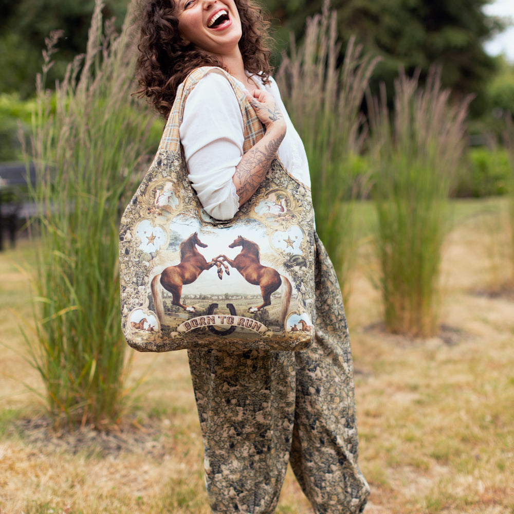 Model wearing a linen tote bag for everyday adventures with a whimsical print celebrating one's unbridled spirit of adventure - Market of Stars
