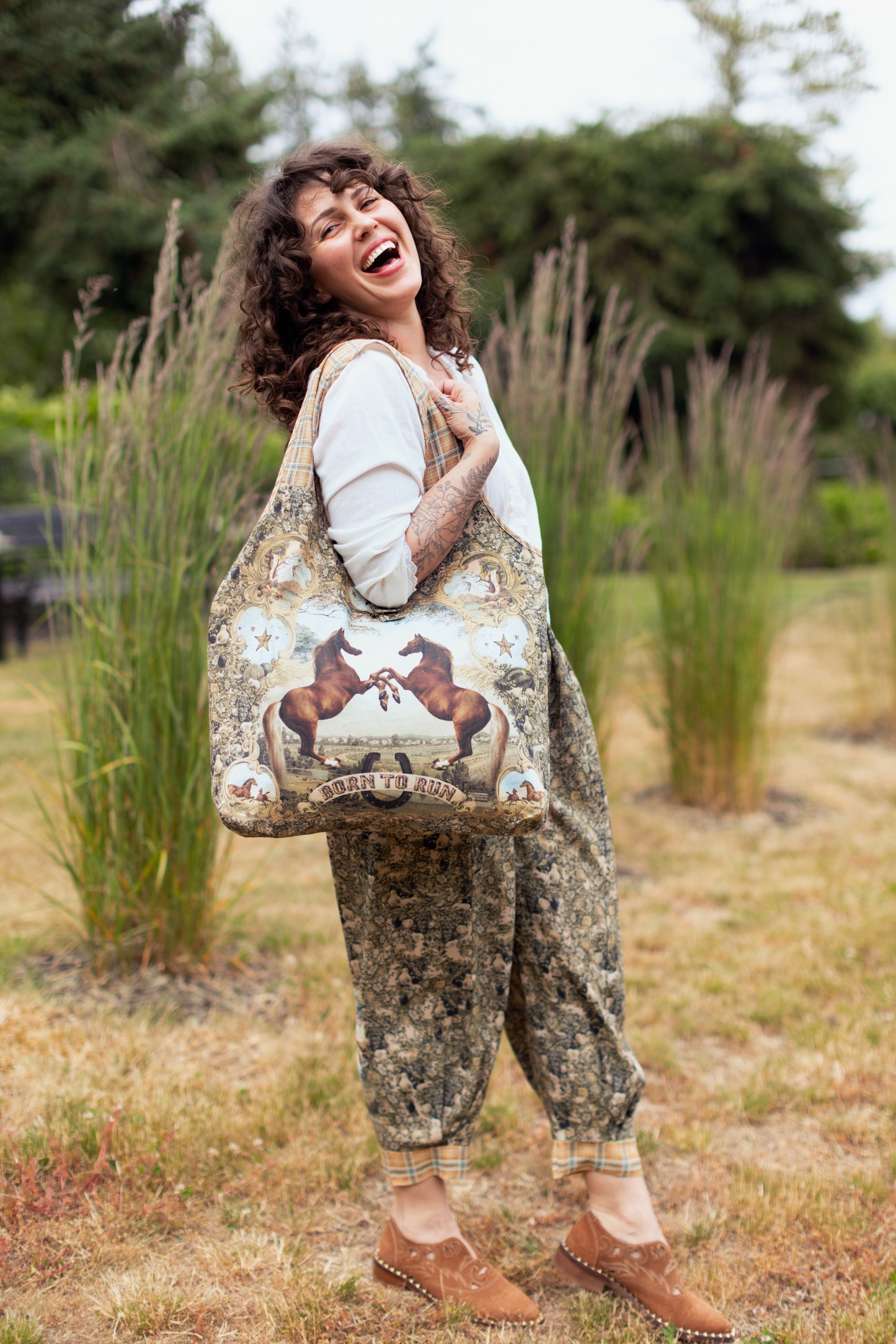 Model wearing a linen tote bag for everyday adventures with a whimsical print celebrating one's unbridled spirit of adventure - Market of Stars