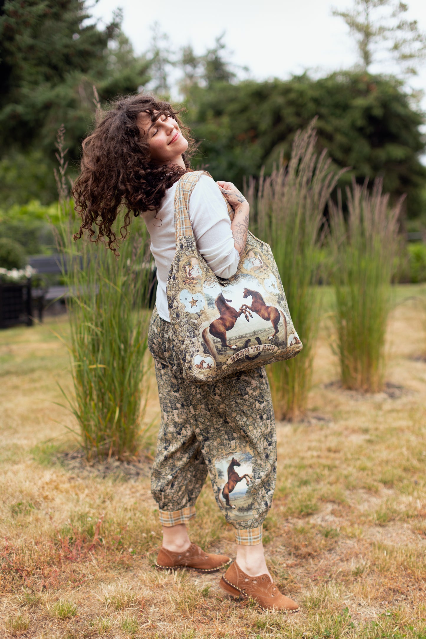 Model wearing a linen tote bag for everyday adventures with a whimsical print celebrating one's unbridled spirit of adventure - Market of Stars