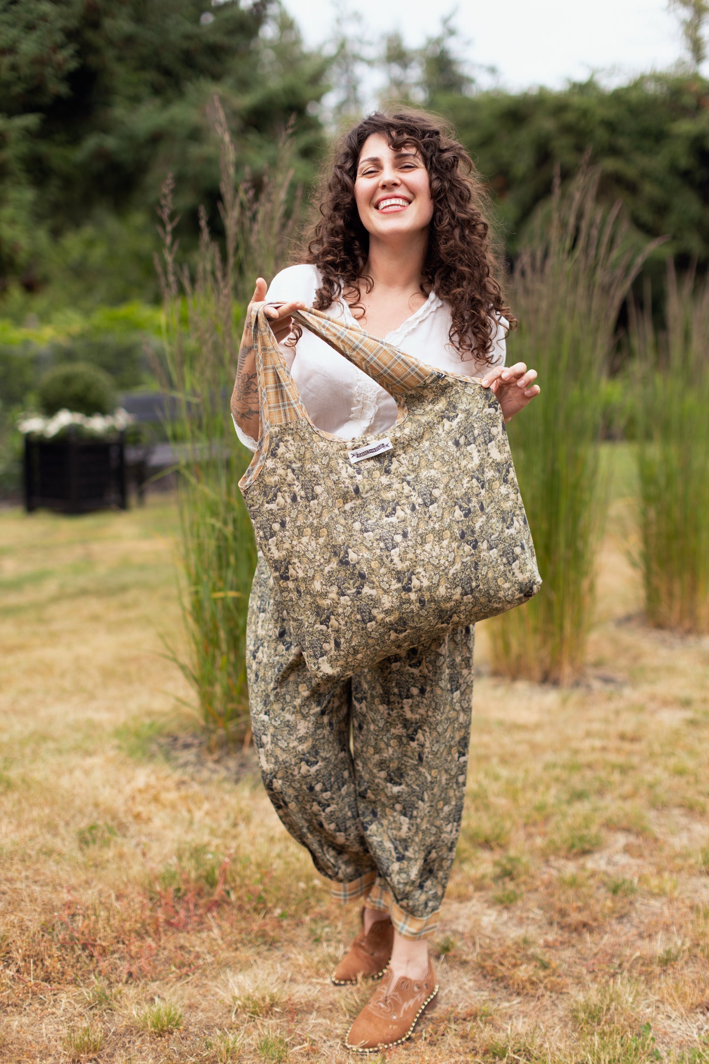Model wearing a linen tote bag for everyday adventures with a whimsical print celebrating one's unbridled spirit of adventure - Market of Stars