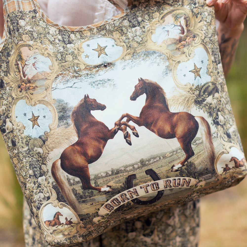 
                  
                    Model wearing a linen tote bag for everyday adventures with a whimsical print celebrating one's unbridled spirit of adventure - Market of Stars
                  
                