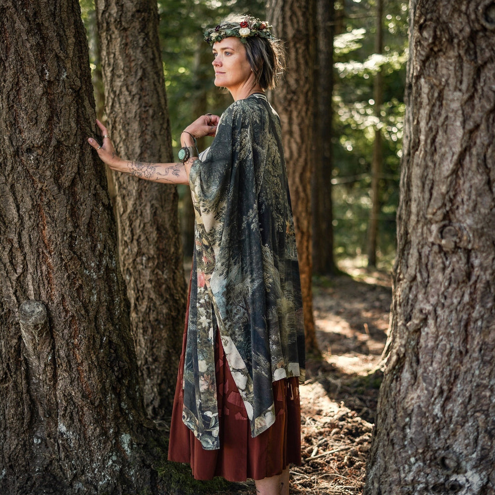 
                  
                    Castles in the Air Starduster kimono featuring Brueghel’s 1600s landscape, classical ruins, and joyful swing scene on bamboo-based viscose – Market of Stars.
                  
                