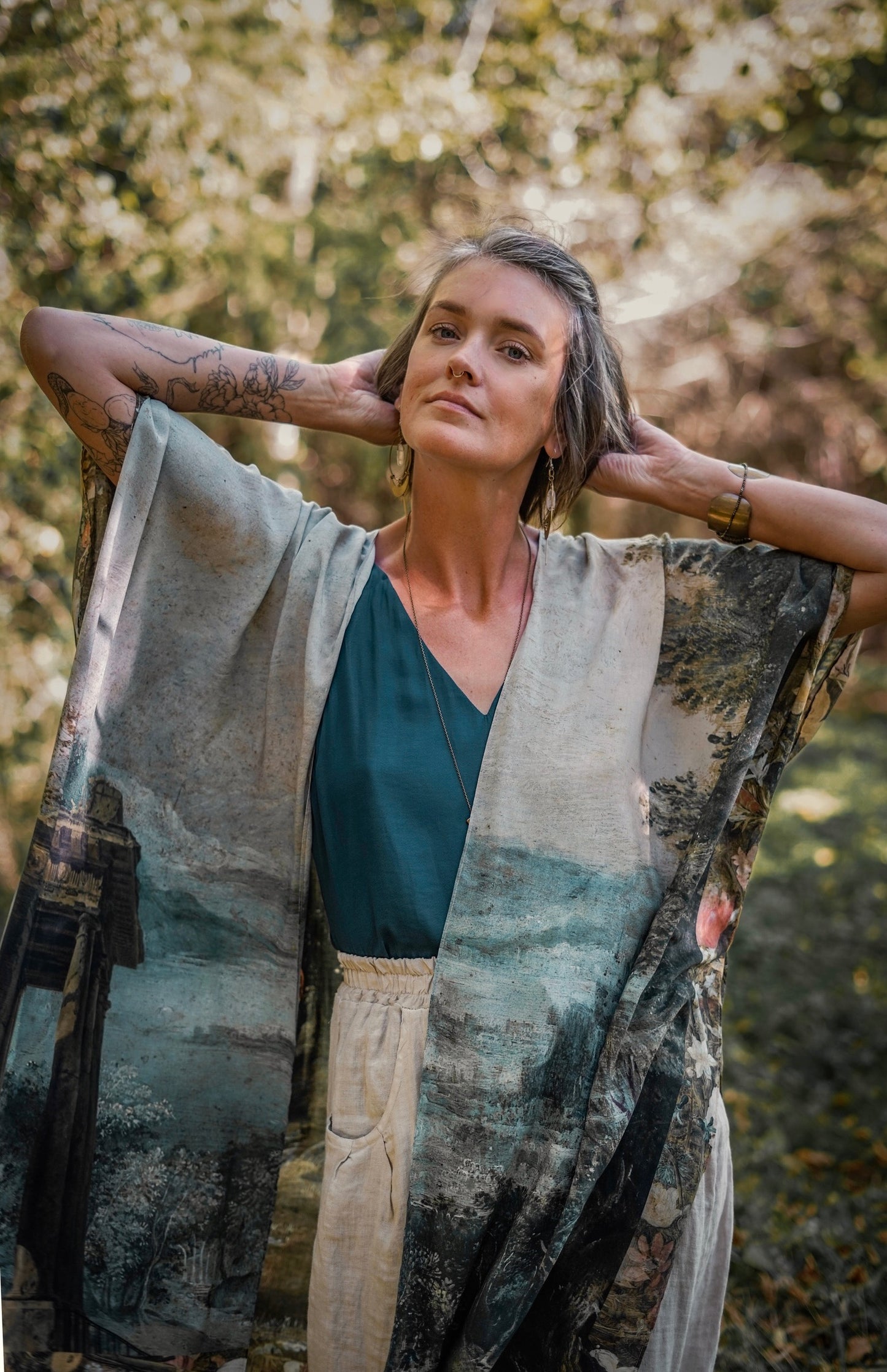 Castles in the Air Starduster kimono featuring Brueghel’s 1600s landscape, classical ruins, and joyful swing scene on bamboo-based viscose – Market of Stars.