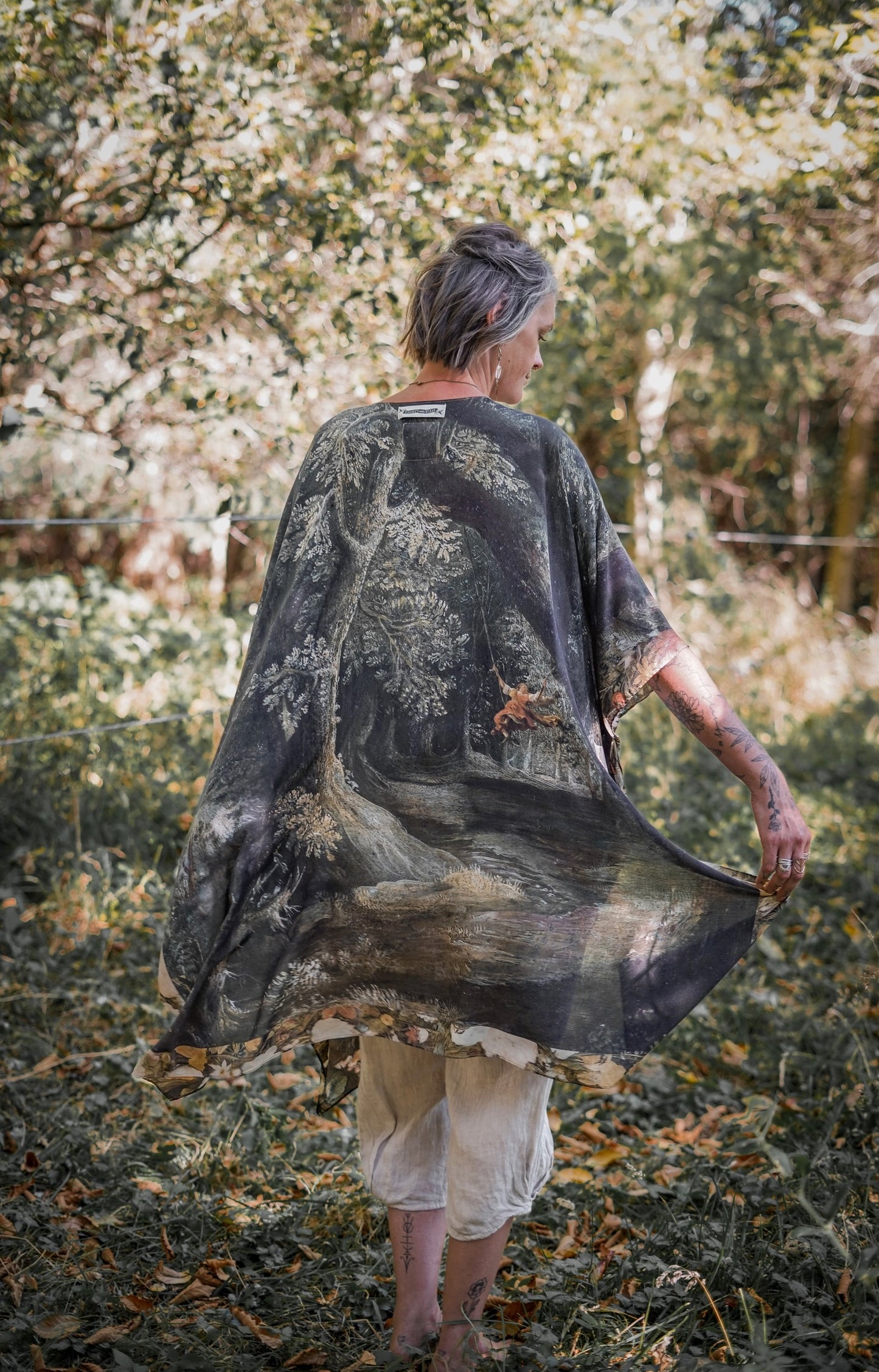 Castles in the Air Starduster kimono featuring Brueghel’s 1600s landscape, classical ruins, and joyful swing scene on bamboo-based viscose – Market of Stars.