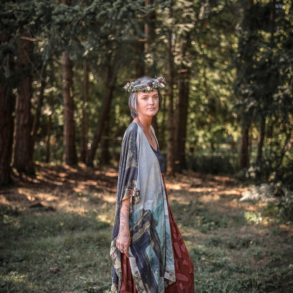 
                  
                    Castles in the Air Starduster kimono featuring Brueghel’s 1600s landscape, classical ruins, and joyful swing scene on bamboo-based viscose – Market of Stars.
                  
                