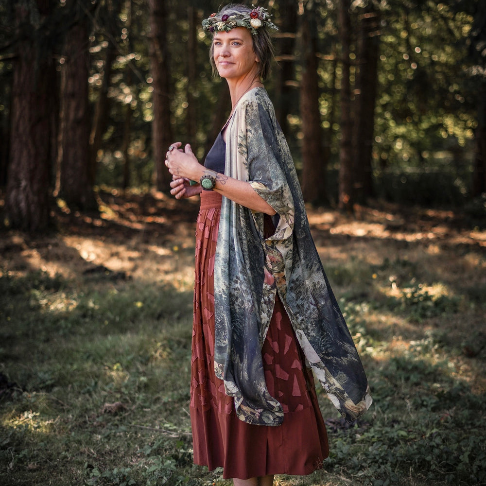 
                  
                    Castles in the Air Starduster kimono featuring Brueghel’s 1600s landscape, classical ruins, and joyful swing scene on bamboo-based viscose – Market of Stars.
                  
                