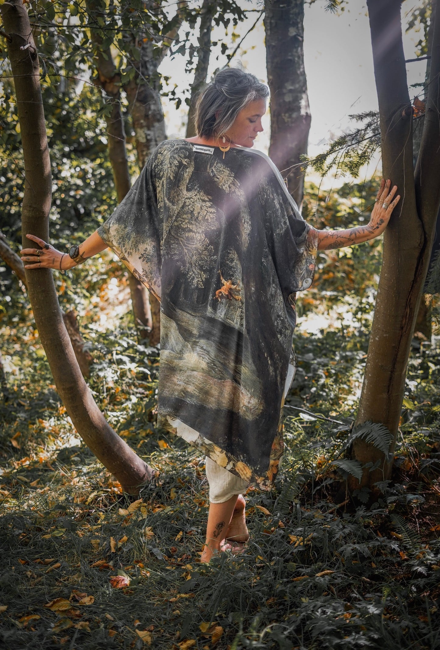 Castles in the Air Starduster kimono featuring Brueghel’s 1600s landscape, classical ruins, and joyful swing scene on bamboo-based viscose – Market of Stars.