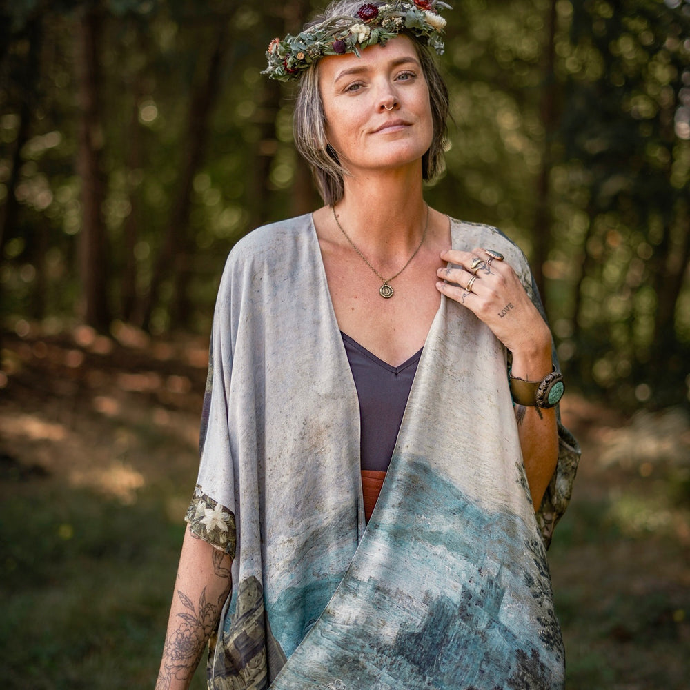 
                  
                    Castles in the Air Starduster kimono featuring Brueghel’s 1600s landscape, classical ruins, and joyful swing scene on bamboo-based viscose – Market of Stars.
                  
                