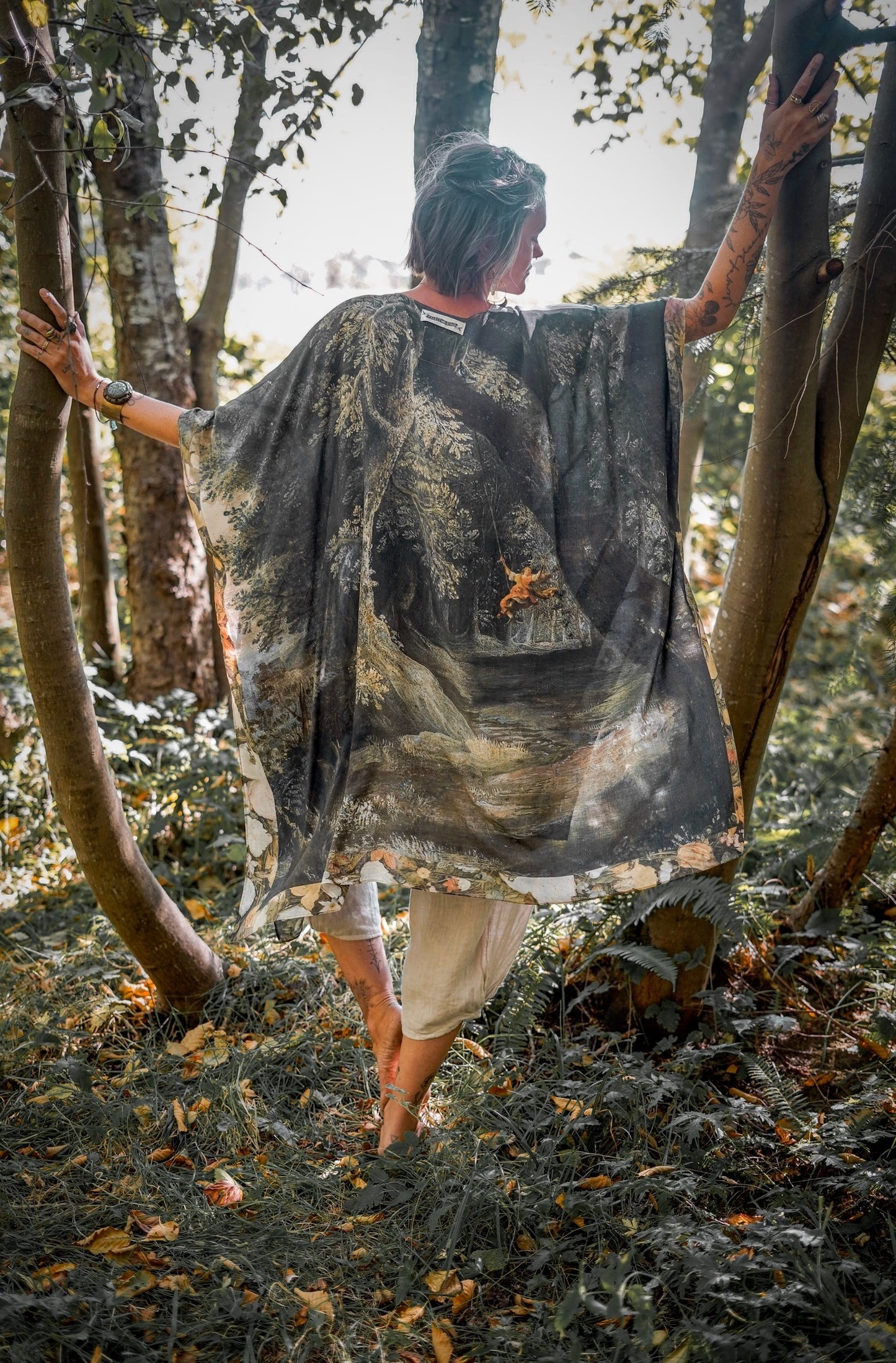 Castles in the Air Starduster kimono featuring Brueghel’s 1600s landscape, classical ruins, and joyful swing scene on bamboo-based viscose – Market of Stars.