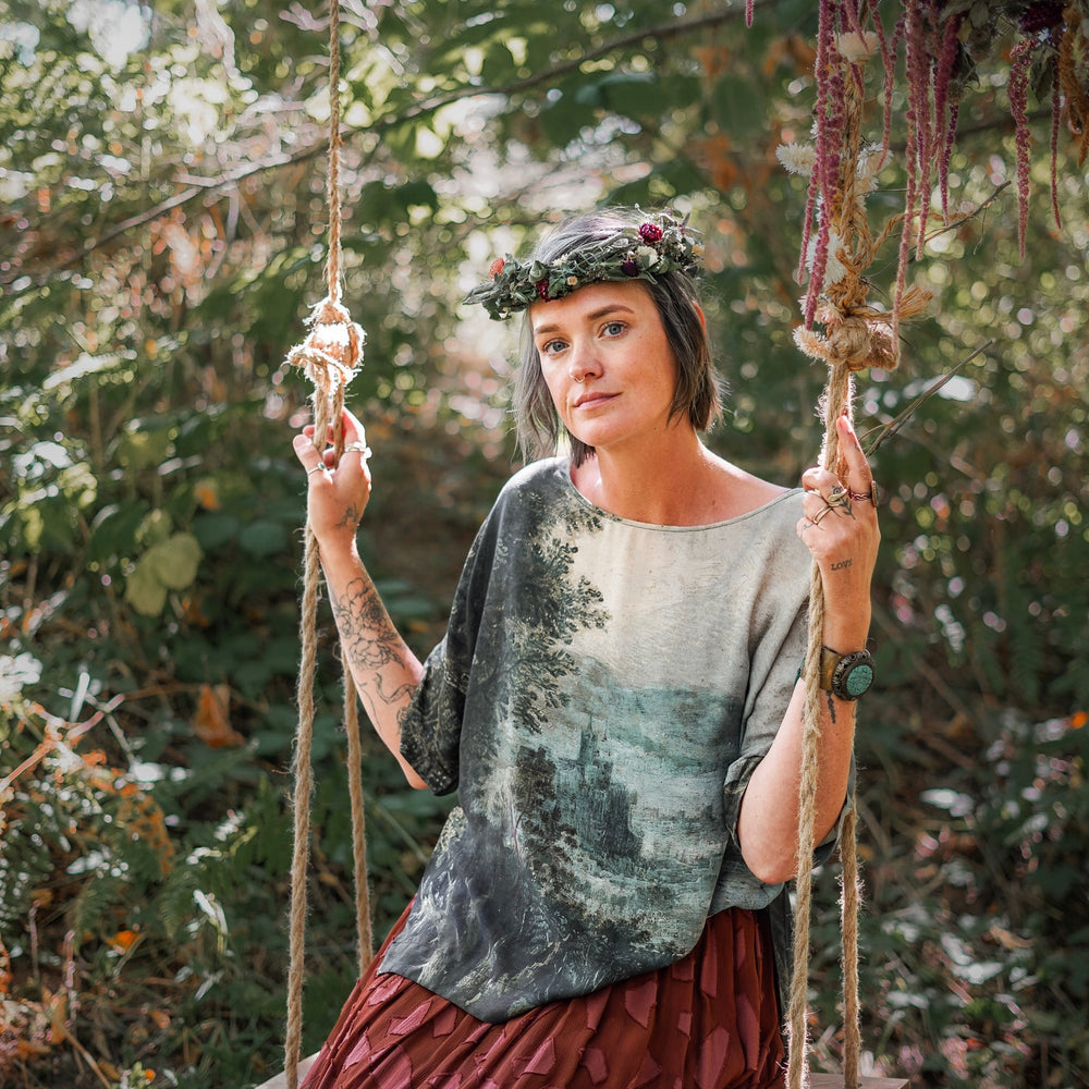 Castles in the Air Luxe Tee featuring Jan Brueghel’s whimsical 1600s landscape and painterly floral trim on soft bamboo-based viscose – Market of Stars.