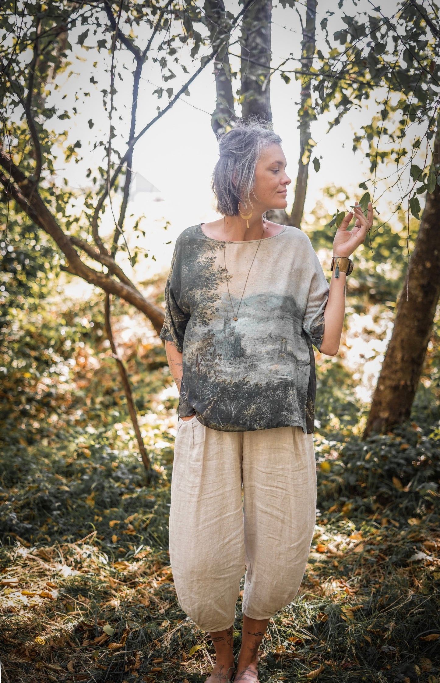 Castles in the Air Luxe Tee featuring Jan Brueghel’s whimsical 1600s landscape and painterly floral trim on soft bamboo-based viscose – Market of Stars.
