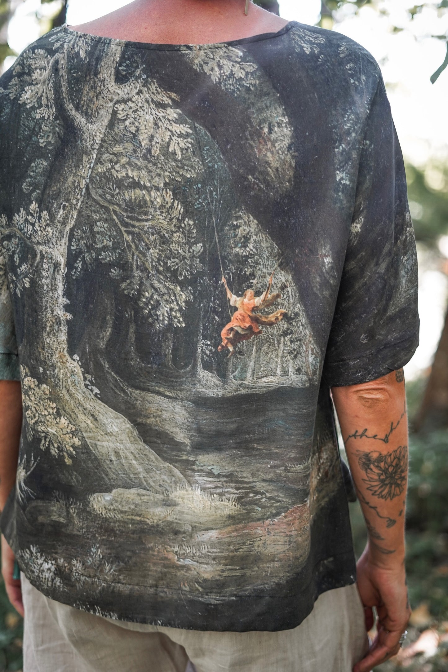 Castles in the Air Luxe Tee featuring Jan Brueghel’s whimsical 1600s landscape and painterly floral trim on soft bamboo-based viscose – Market of Stars.