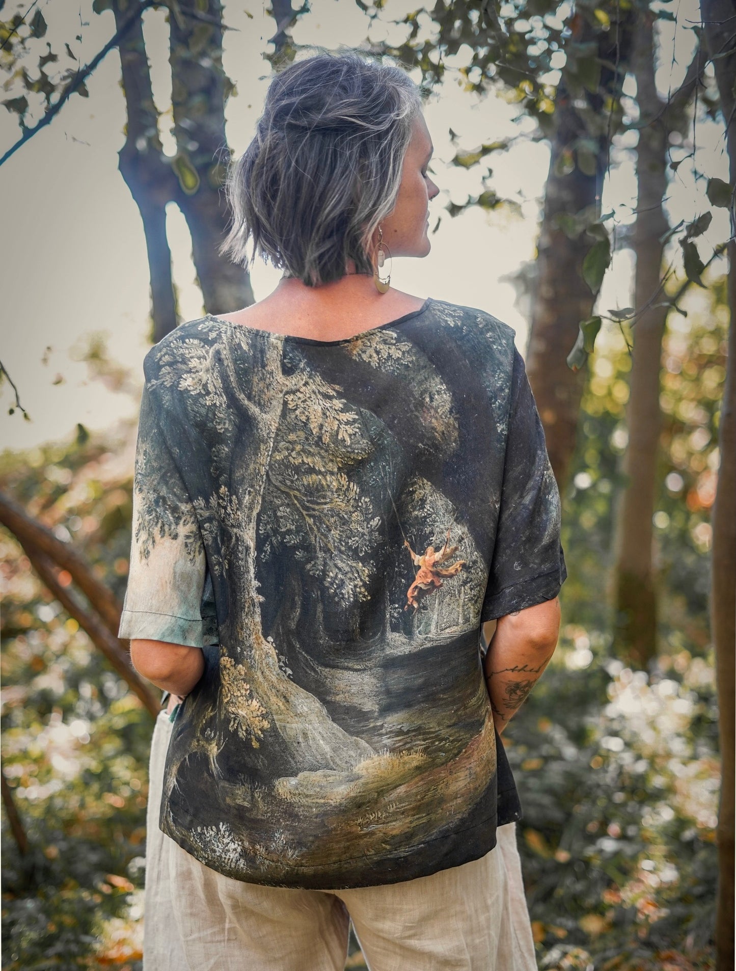 Castles in the Air Luxe Tee featuring Jan Brueghel’s whimsical 1600s landscape and painterly floral trim on soft bamboo-based viscose – Market of Stars.