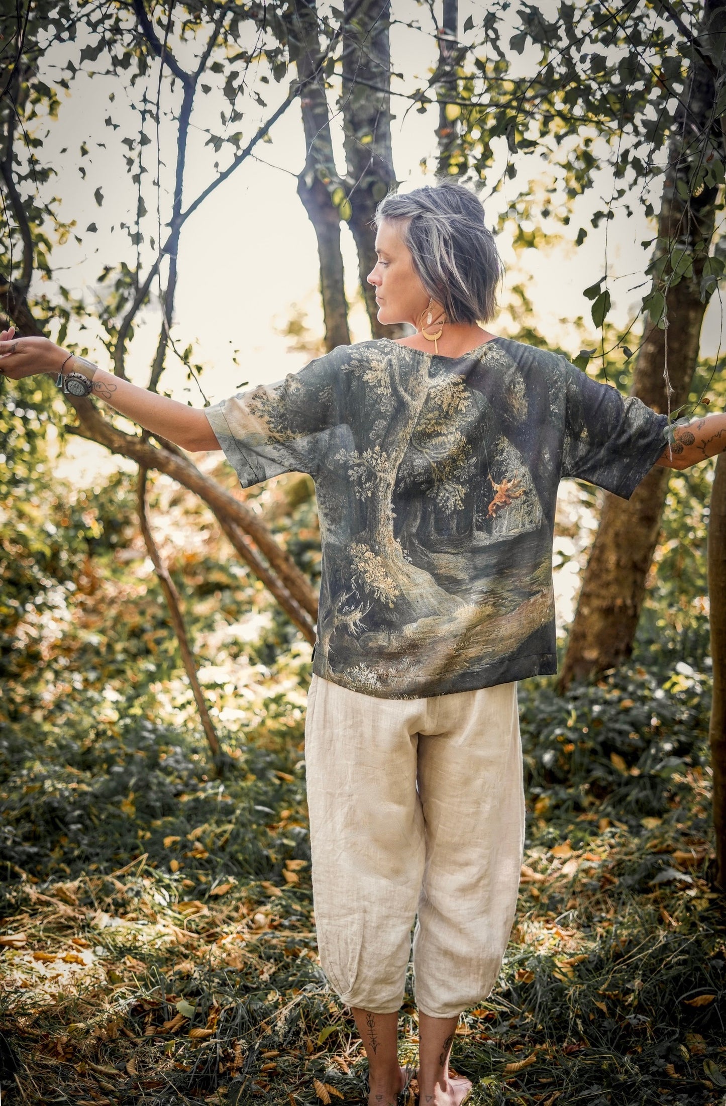 Castles in the Air Luxe Tee featuring Jan Brueghel’s whimsical 1600s landscape and painterly floral trim on soft bamboo-based viscose – Market of Stars.