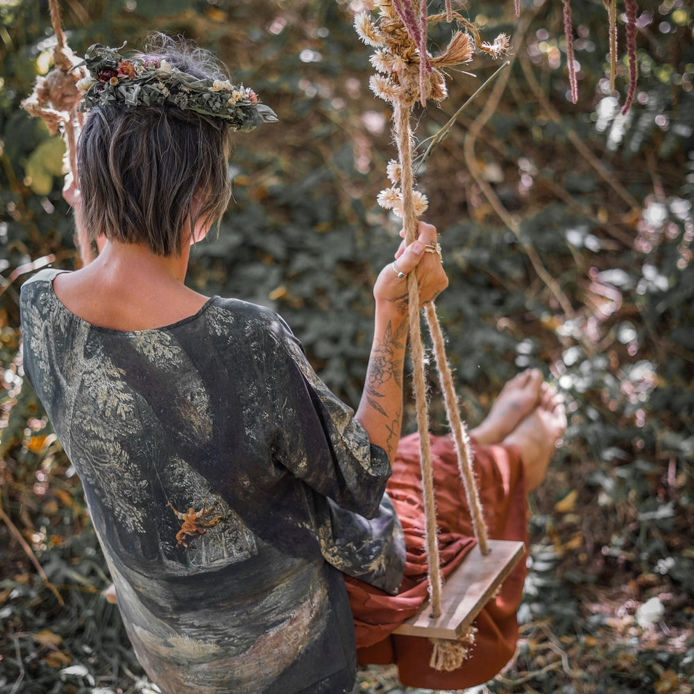 
                  
                    Castles in the Air Luxe Tee featuring Jan Brueghel’s whimsical 1600s landscape and painterly floral trim on soft bamboo-based viscose – Market of Stars.
                  
                