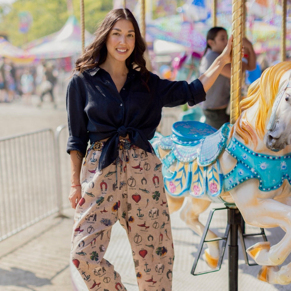 
                  
                    Charmed Life Artist Pants featuring playful Victorian luck charms and floral trim on breathable linen & bamboo/wood viscose – Market of Stars.
                  
                
