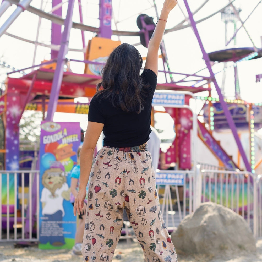 
                  
                    Charmed Life Artist Pants featuring playful Victorian luck charms and floral trim on breathable linen & bamboo/wood viscose – Market of Stars.
                  
                