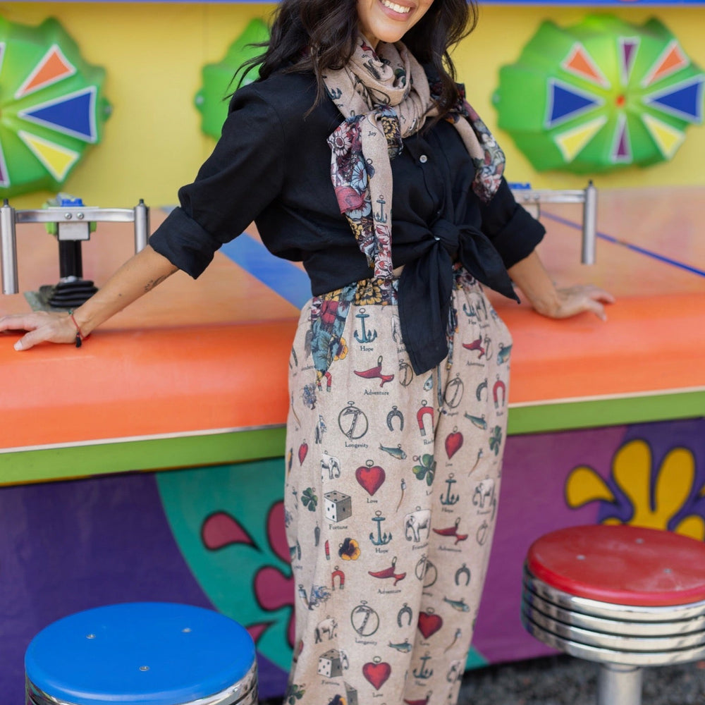 
                  
                    Charmed Life Artist Pants featuring playful Victorian luck charms and floral trim on breathable linen & bamboo/wood viscose – Market of Stars.
                  
                
