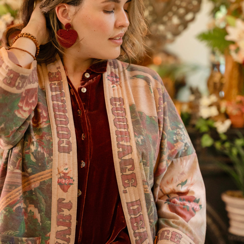 
                  
                    Cozy Courage Dear Heart Cottage Jacket featuring Victorian Sacred Heart art, hidden affirmations of courage and love, and soft fleece lining for cooler days – Market of Stars.
                  
                