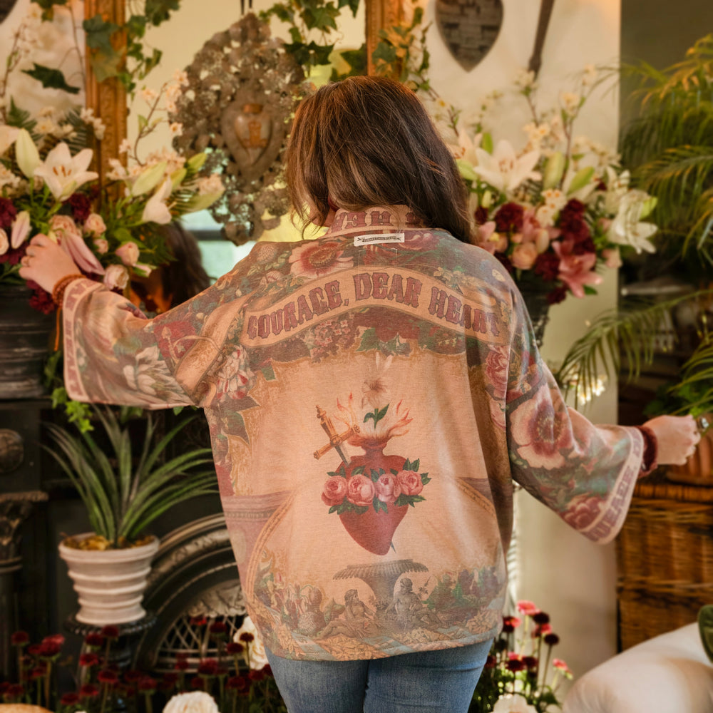 
                  
                    Cozy Courage Dear Heart Cottage Jacket featuring Victorian Sacred Heart art, hidden affirmations of courage and love, and soft fleece lining for cooler days – Market of Stars.
                  
                