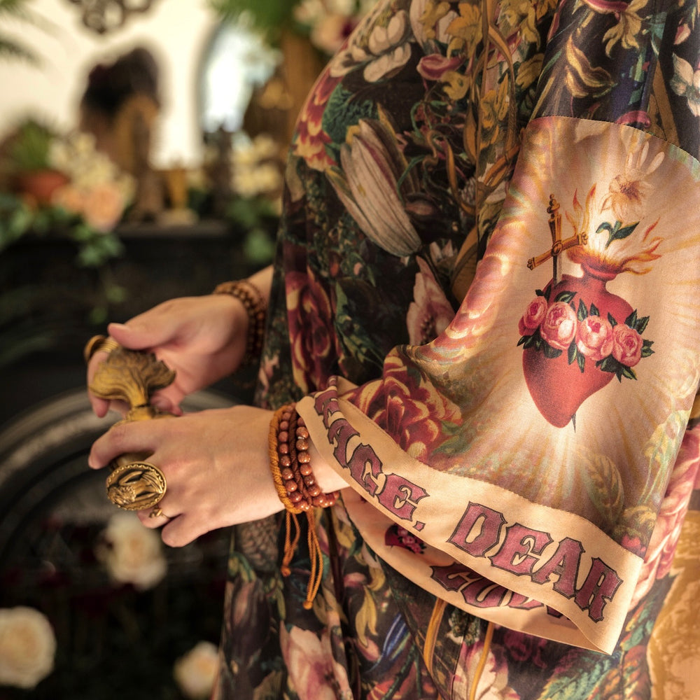 
                  
                    Model wearing Take Heart Opera Duster featuring Victorian Sacred Heart art, hidden affirmations of love, courage, and strength on bamboo-based viscose – Market of Stars
                  
                