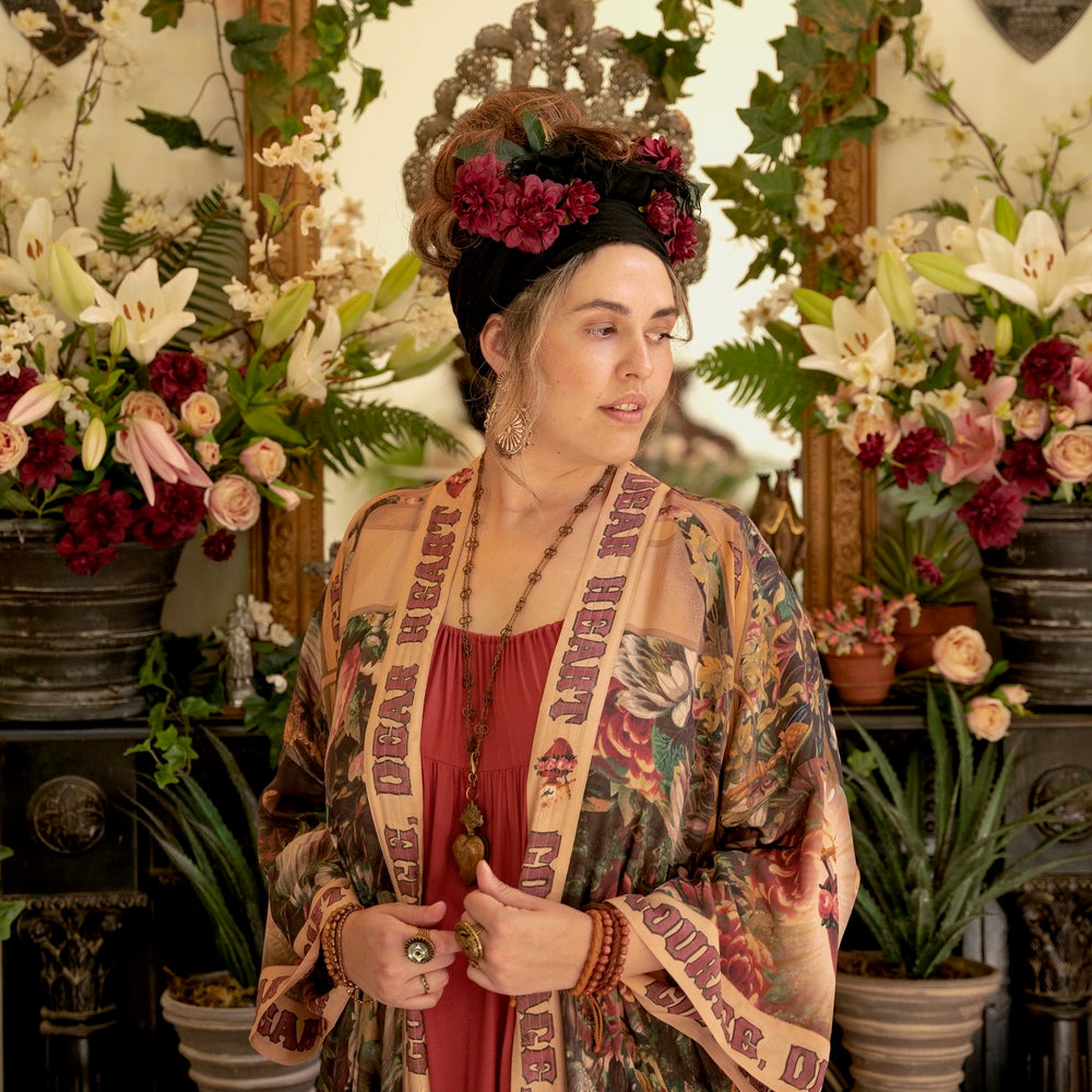 
                  
                    Model wearing Take Heart Opera Duster featuring Victorian Sacred Heart art, hidden affirmations of love, courage, and strength on bamboo-based viscose – Market of Stars
                  
                