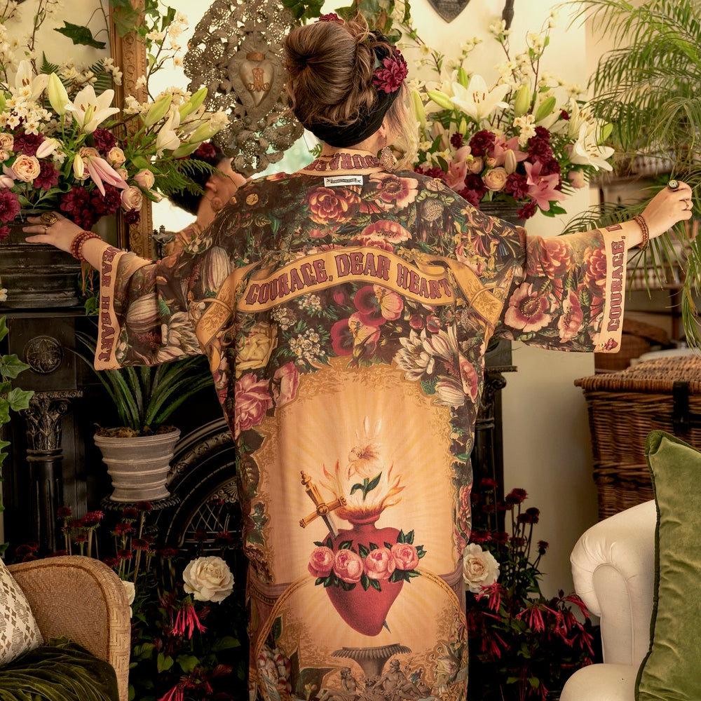 
                  
                    Model wearing Take Heart Opera Duster featuring Victorian Sacred Heart art, hidden affirmations of love, courage, and strength on bamboo-based viscose – Market of Stars
                  
                