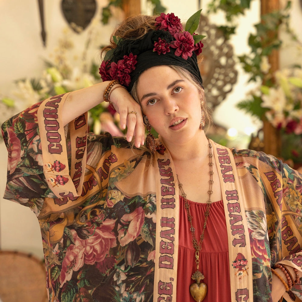 
                  
                    Model wearing Take Heart Opera Duster featuring Victorian Sacred Heart art, hidden affirmations of love, courage, and strength on bamboo-based viscose – Market of Stars
                  
                