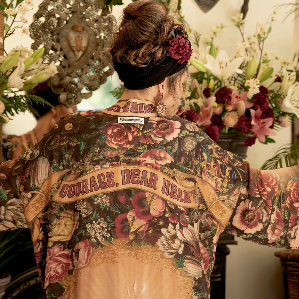 
                  
                    Model wearing Take Heart Opera Duster featuring Victorian Sacred Heart art, hidden affirmations of love, courage, and strength on bamboo-based viscose – Market of Stars
                  
                
