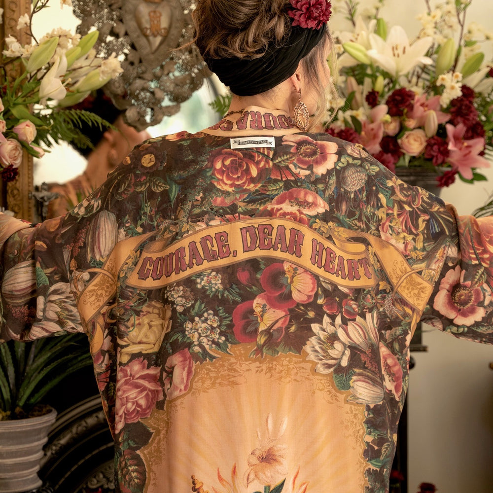 
                  
                    Model wearing Take Heart Opera Duster featuring Victorian Sacred Heart art, hidden affirmations of love, courage, and strength on bamboo-based viscose – Market of Stars
                  
                