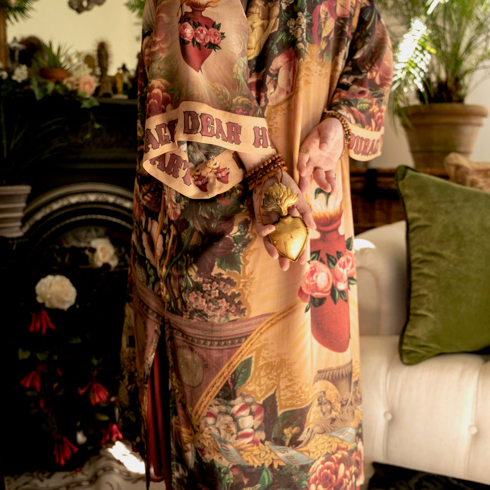 
                  
                    Model wearing Take Heart Opera Duster featuring Victorian Sacred Heart art, hidden affirmations of love, courage, and strength on bamboo-based viscose – Market of Stars
                  
                