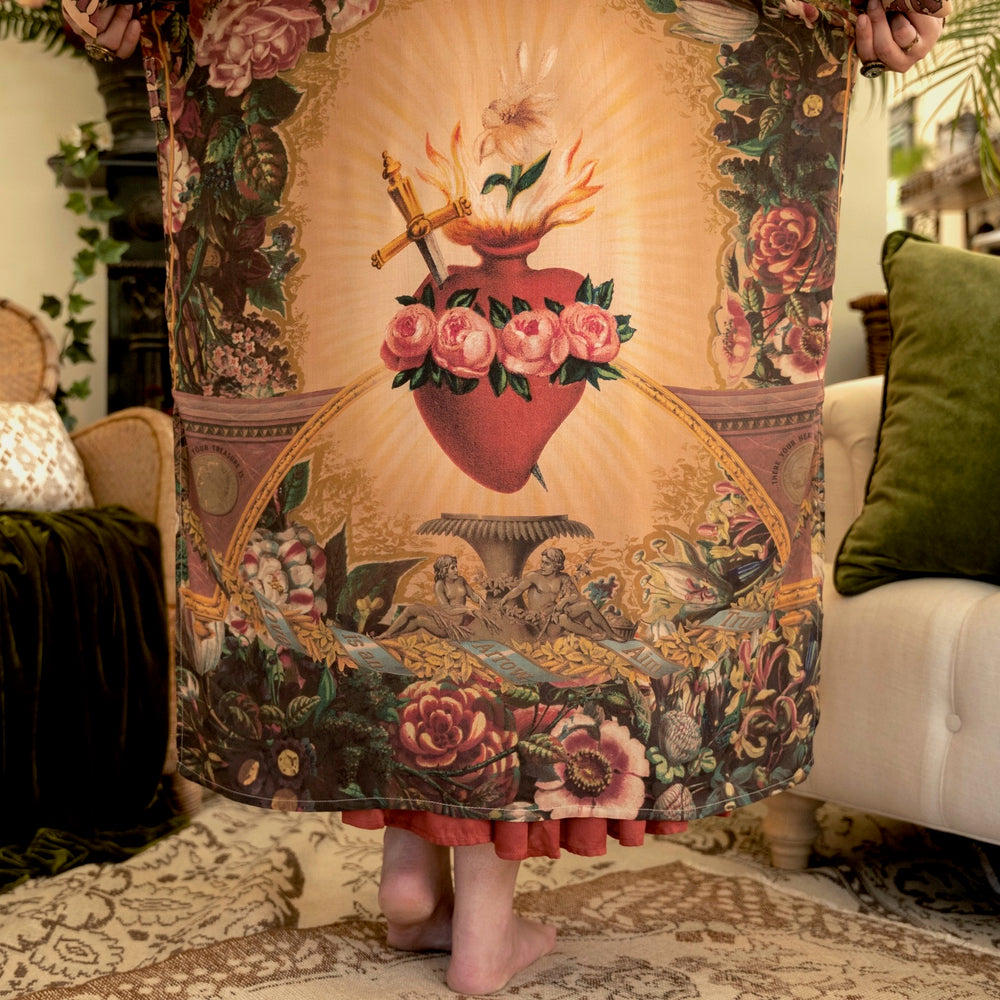 
                  
                    Model wearing Take Heart Opera Duster featuring Victorian Sacred Heart art, hidden affirmations of love, courage, and strength on bamboo-based viscose – Market of Stars
                  
                