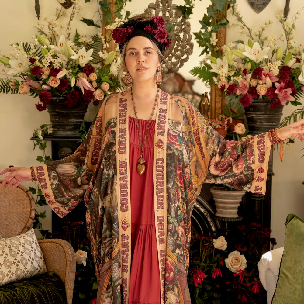 
                  
                    Model wearing Take Heart Opera Duster featuring Victorian Sacred Heart art, hidden affirmations of love, courage, and strength on bamboo-based viscose – Market of Stars
                  
                