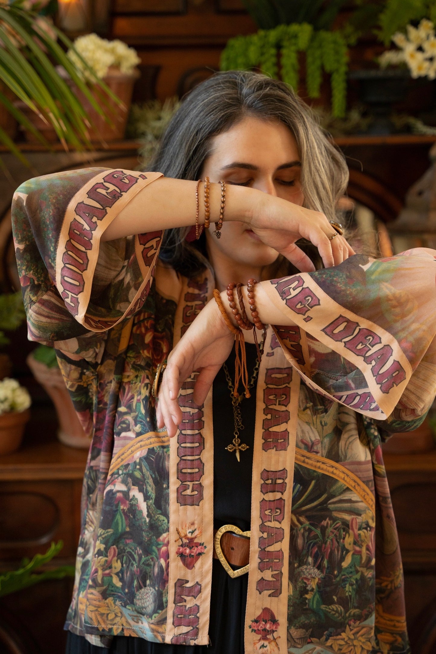 Model wearing Courage Dear Heart Pixie cut Duster featuring Victorian Sacred Heart art and hidden affirmations of courage and love on bamboo-based viscose – Market of Stars.