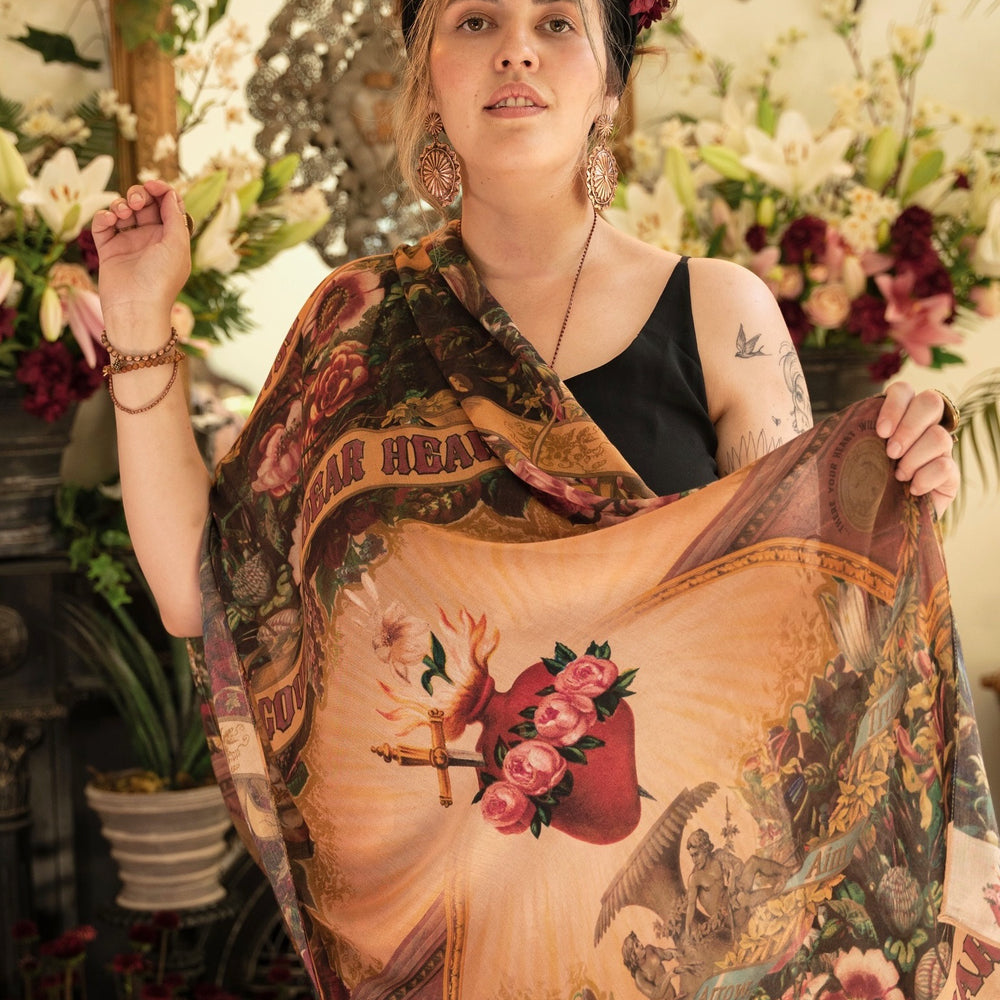 Model wearing Courage Dear Heart scarf featuring Victorian lithographs, Sacred Heart art, and hidden messages of love, faith, and courage on soft bamboo viscose – Market of Stars